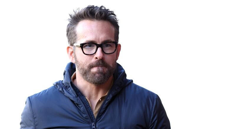 Actor Ryan Reynolds looks on during a soccer match.