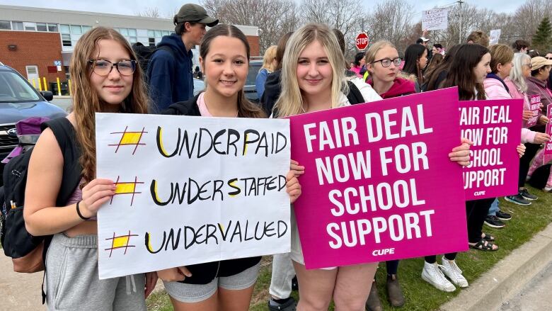 Students from Cole Harbour District High School joined their school support workers on the picket lines holding pink signs.