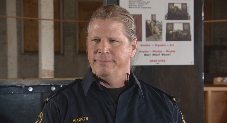 A man in uniform with a ponytail is pictured. 