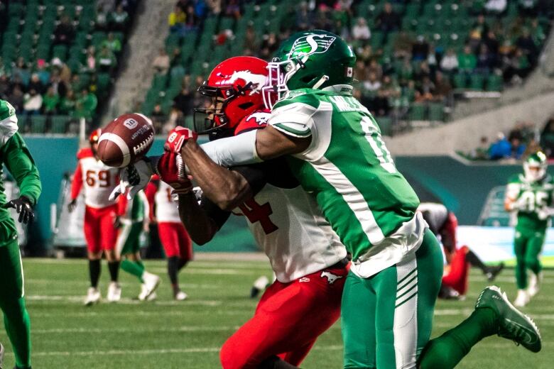 Two football players crash together on the field.