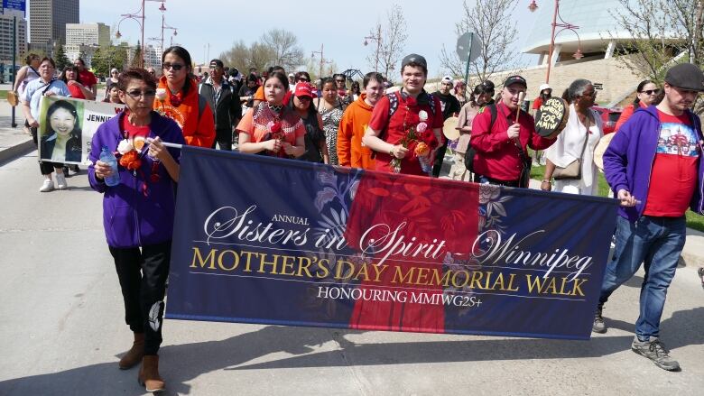 A group of people marching are pictured.