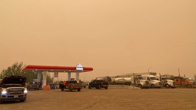 A gas station against a smoky sky.