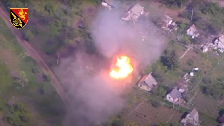 An aerial view of an explosion in a village