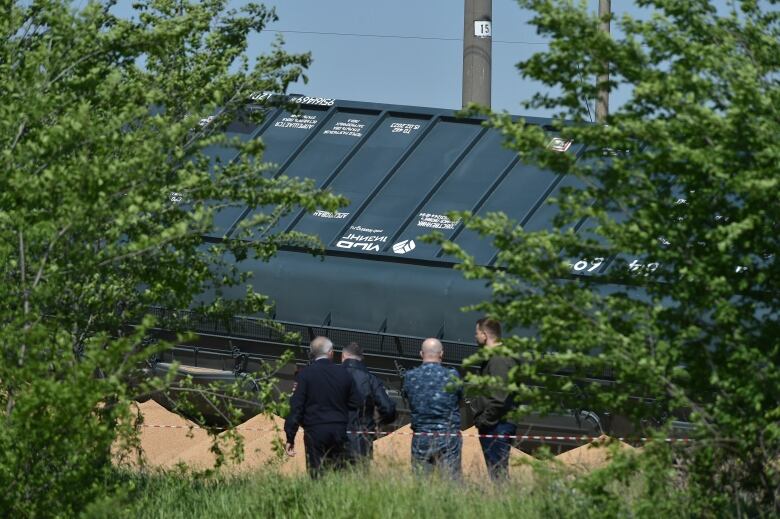 A derailed train car sits sideways on a track.