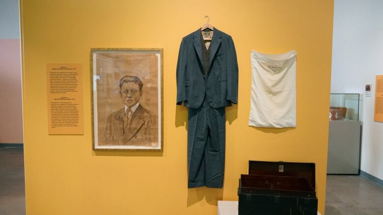 JJ Lee's exhibition begins with her grandfather Lee Wong, whose seen here in an illustration by Lee, alongside artifacts of clothing.