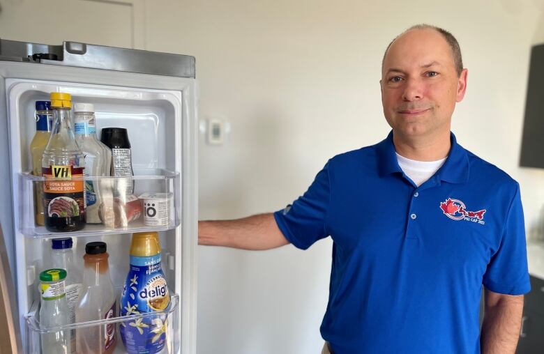 man next to a fridge