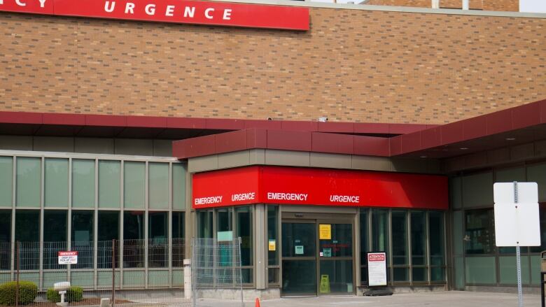 The exterior of a brick building with red 