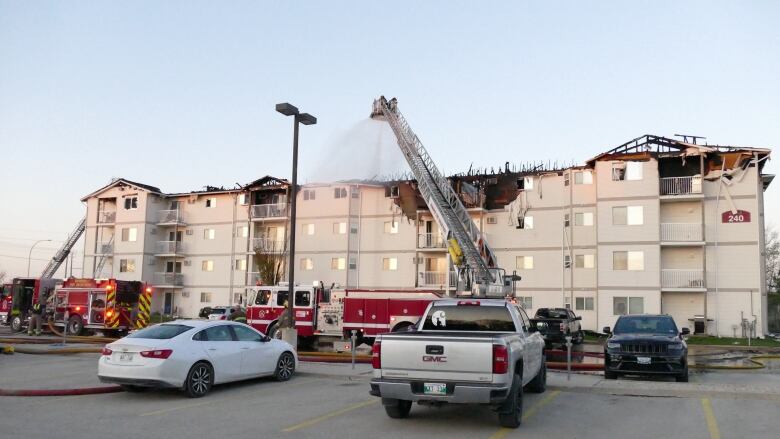 Firefighters are pictured tackling an apartment blaze using an aerial ladder.