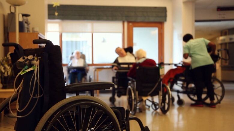 Seniors in a wheelchair at a long-term care home. 