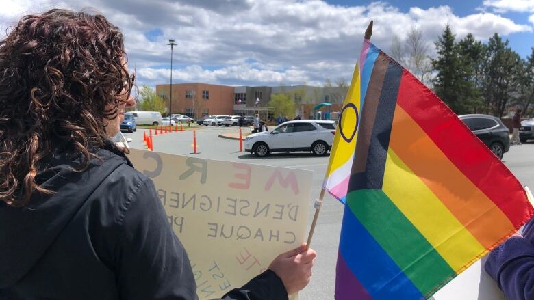 a person holding a Beaubassin School pride flag in Halifax on 19 May 2023.