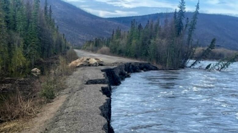 A partially washed-out section of gravel road.