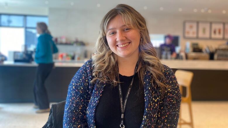 A woman smiles at the camera.