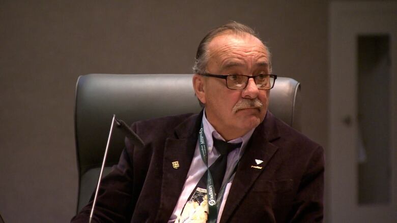 Man in city council chambers.