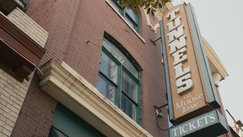 A sign for the Moose Jaw tunnels is shown on the building.