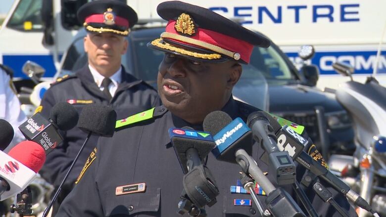 Marc Andrews stands at a podium during a news conference