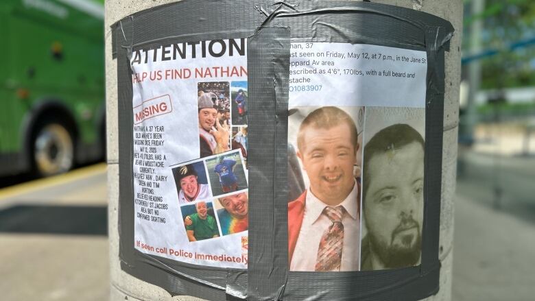 Two posters taped with duct tape to a cement pole, one has two photos of a man with Down syndrome