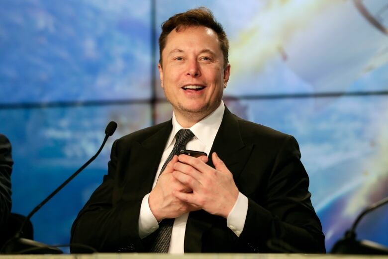 Elon Musk speaking at a news conference.