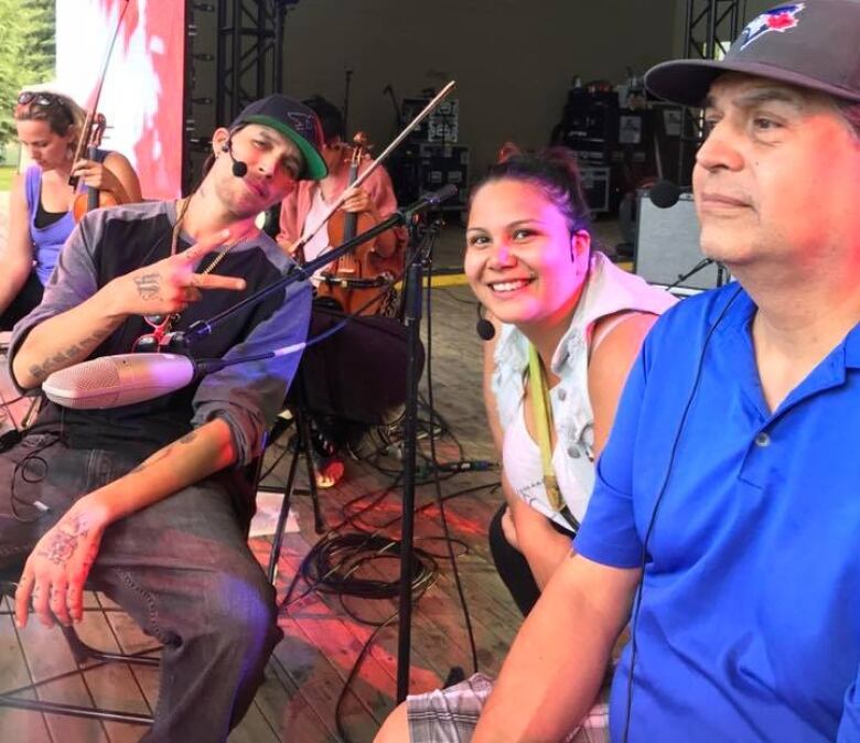 Indigenous singers with symphonic musicians in the foreground