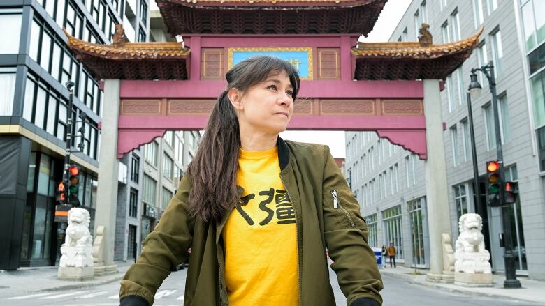 woman in front of the entrance to Montreal's Chinatown.