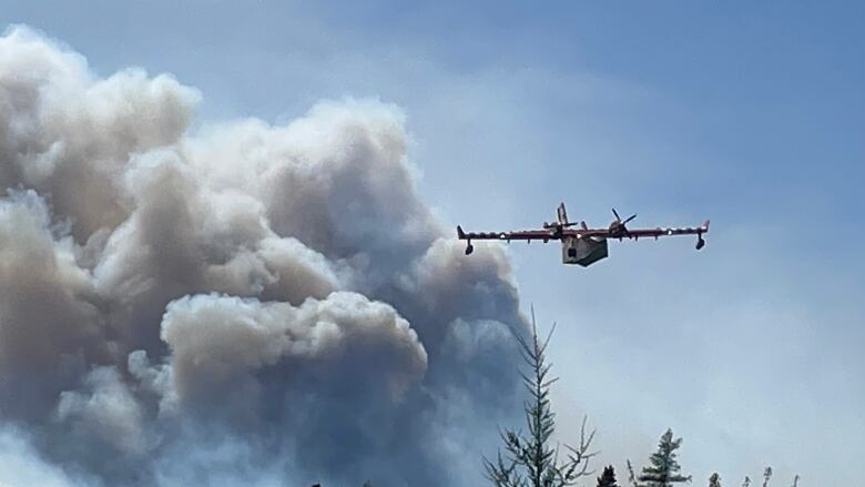 An aircraft flies over the wildfire in Shelburne County, N.S.