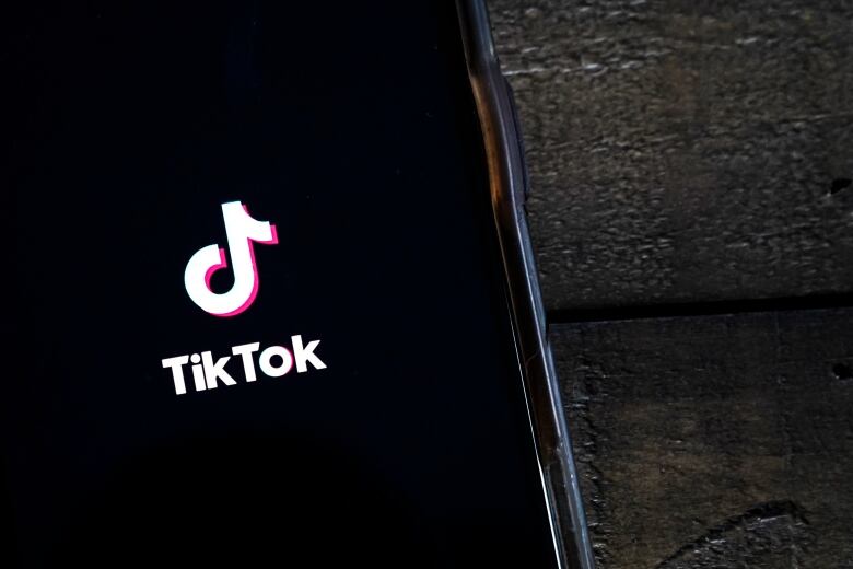 A phone screen with the TikTok app logo on it.