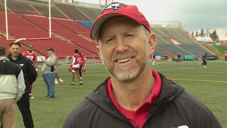 A man smiles into the camera.