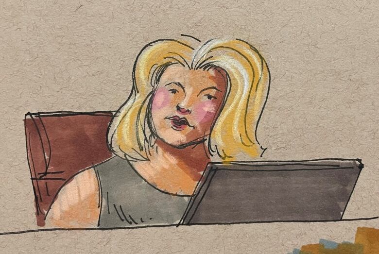 A woman sits in a courtroom