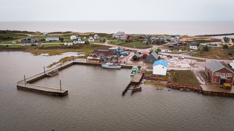 An aerial photo shows the North Rustico Harbour two days after the storm. Parking lots are flooded.