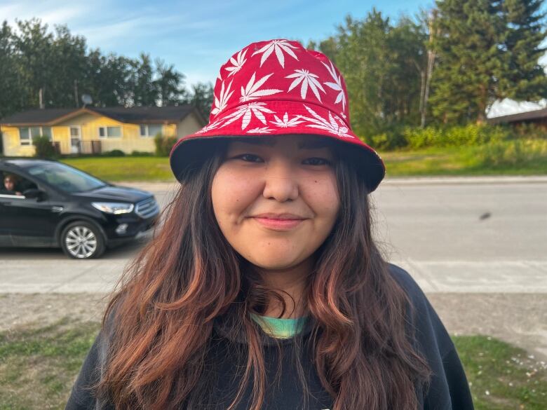 A girl wearing a hand stares into a camera. 