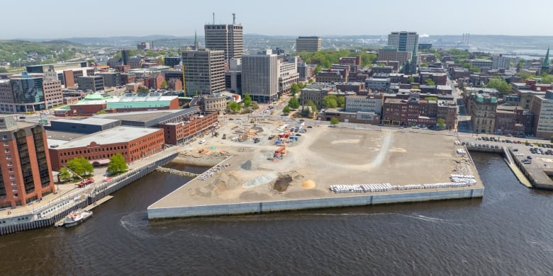 An aerial shot of a city's waterfront with an active construction site. 