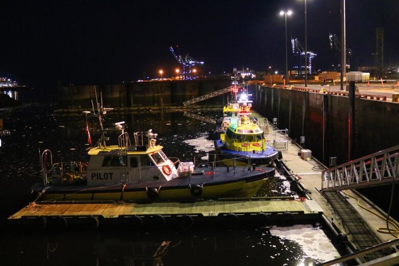 Nightime at Long Wharf - black water, swirling sea boat, and no one around except the pilot boat captains and crew. 