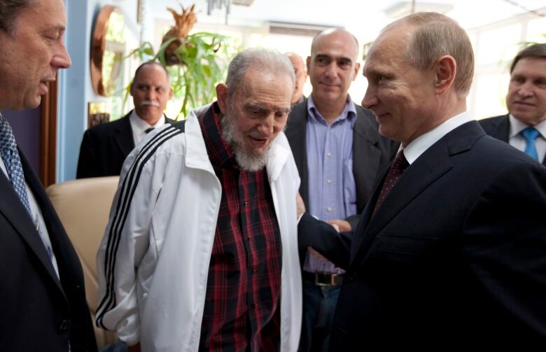 Cuba's Fidel Castro, center, meets with Russia's President Vladimir Putin, right, in Havana, Cuba, Friday, July 11, 2014. Putin began a Latin American tour aimed at boosting trade and ties in the region with a stop Friday in Cuba, a key Soviet ally during the Cold War that has backed Moscow in its dispute with the West over Ukraine.