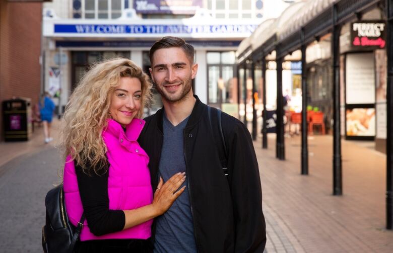 Virginie Primeau and Nikita Druzhynin stand in front of the Winter Gardens ballroom in Blackpool, England.