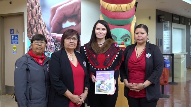 Four women standing together.