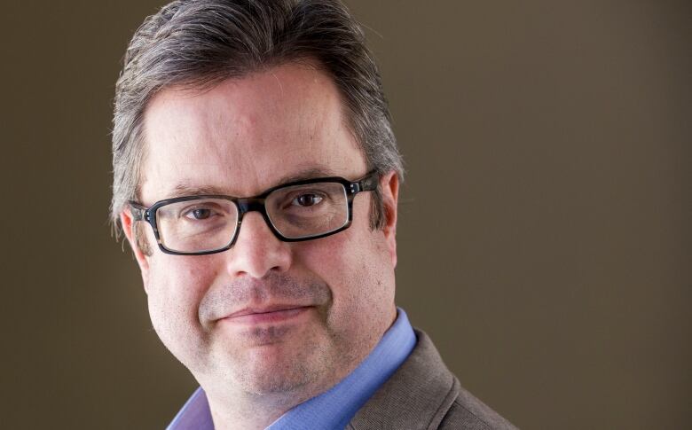 Closeup of a man wearing glasses. 