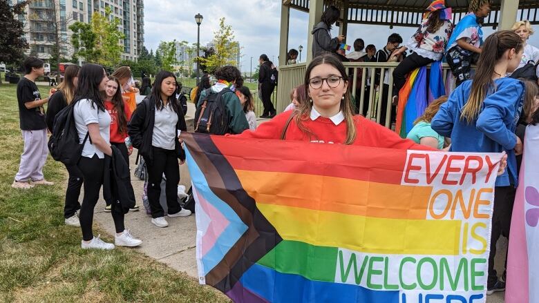 A student holds a Pride flag