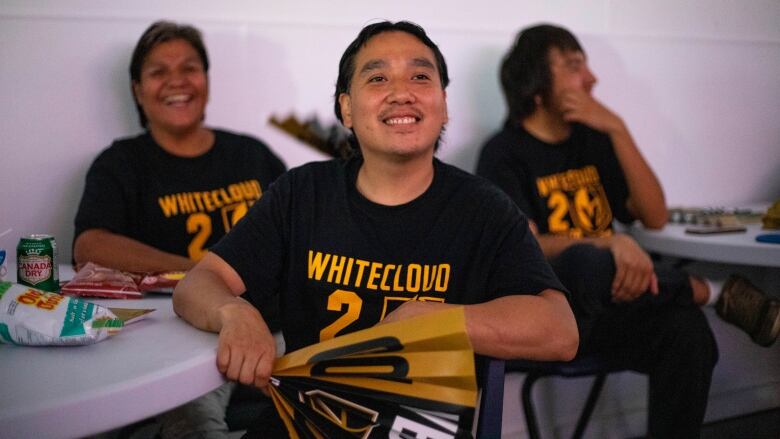 A man smiles wearing a Las Vegas Golden Knights t-shirt.