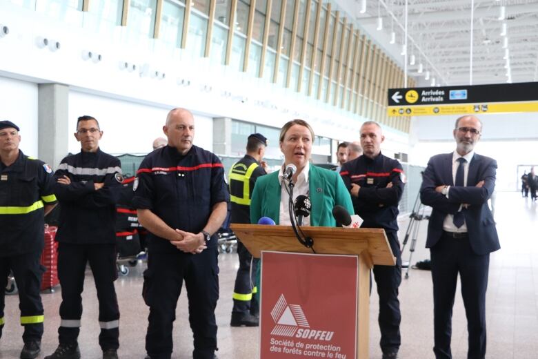 ric Flores, who will lead the French firefighting team in Quebec, stands to the left of Quebec's Minister of Forestry Mat Blanchette Vzina. 