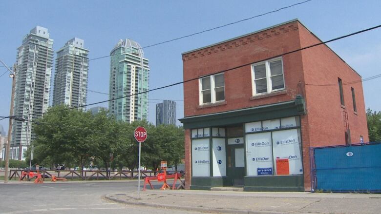 A square red building sits on the corner of two streets. 