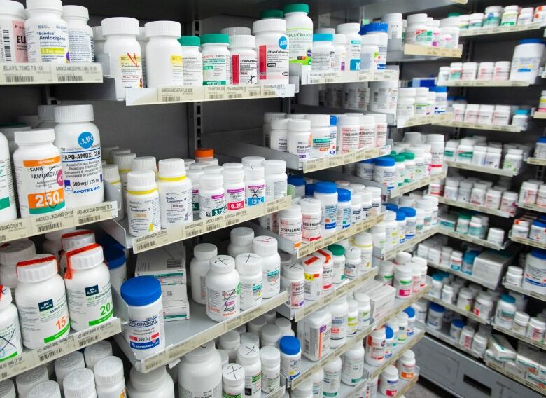 Pharmaceutical drugs sitting on shelves.