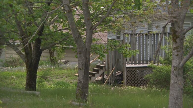 A wooden deck is attached to a home.