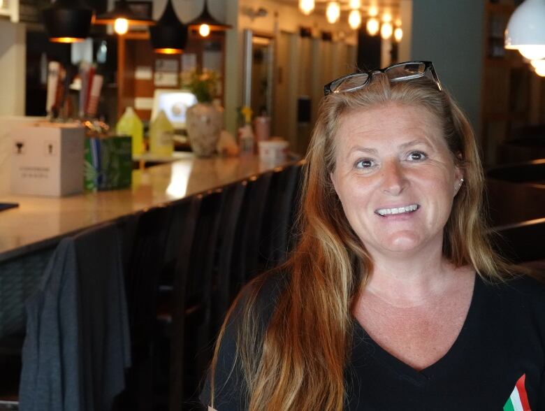 An Italian restaurant manager poses for a photo.