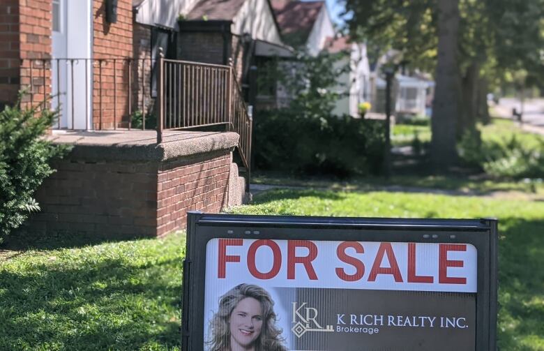 A for sale sign at a home in Windsor, Ontario.