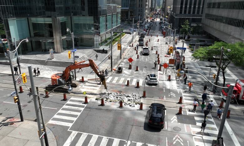 Construction at an intersection reducing traffic to one lane across the street out of the intersection.