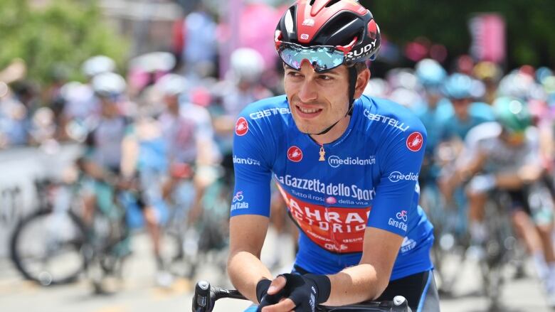 A cyclist is shown wearing a helmet, biking gloves and jersey.