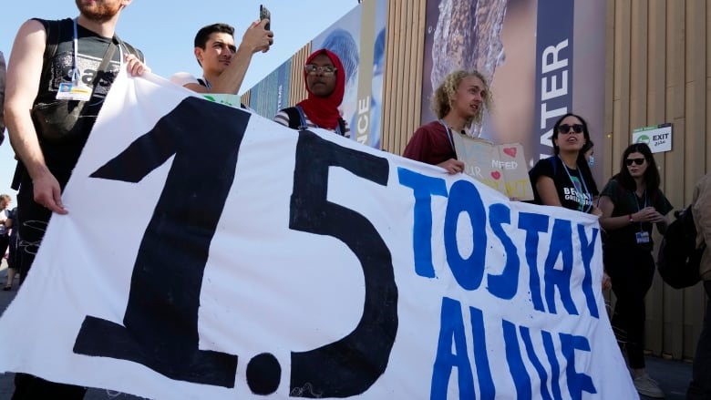 Demonstrators rally in support of the 1.5 C global warming limit at the 2022 COP27 climate summit in Egypt. 