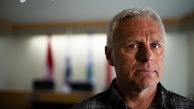 Close up of a man's face. He has white hair.