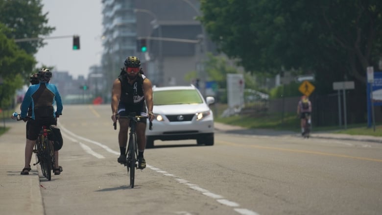 A cyclist rides down in a bike lane in the National Capital region Friday, June 16, 2023.