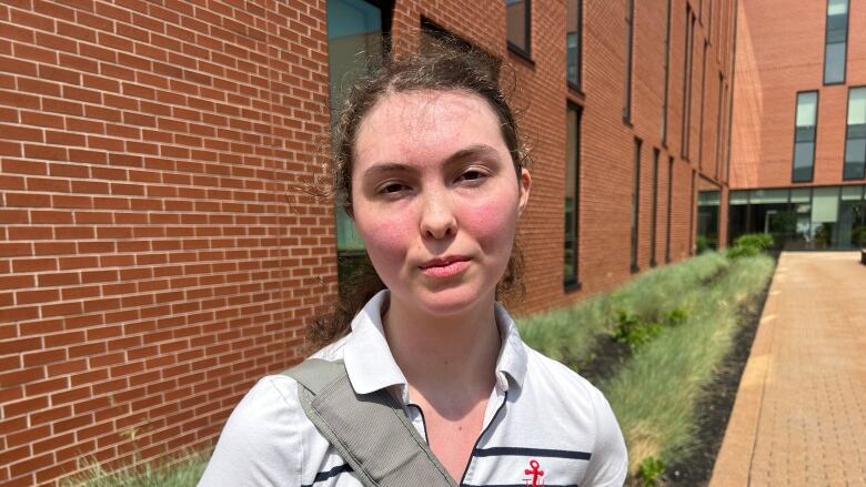 UPEI student Caitlin Wildman standing outside a building on campus.