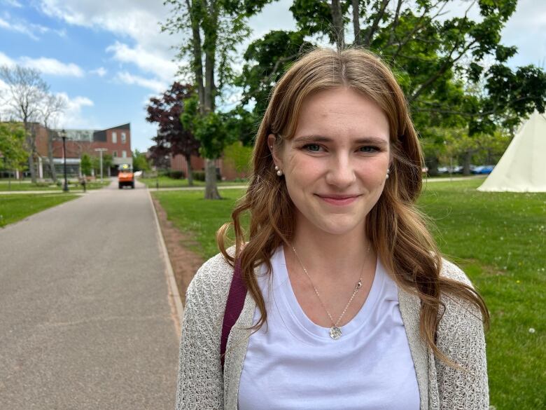 UPEI student Grace Meade stands at a courtyard at the university.